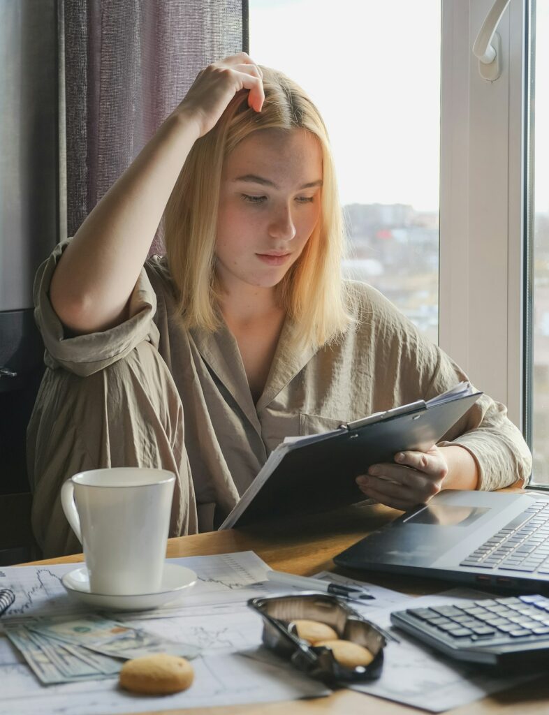 Investments. Young woman investor buys stocks on the stock exchange stock market from home